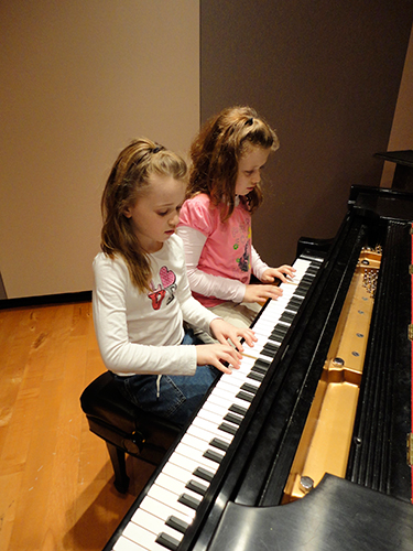 Girls playing piano